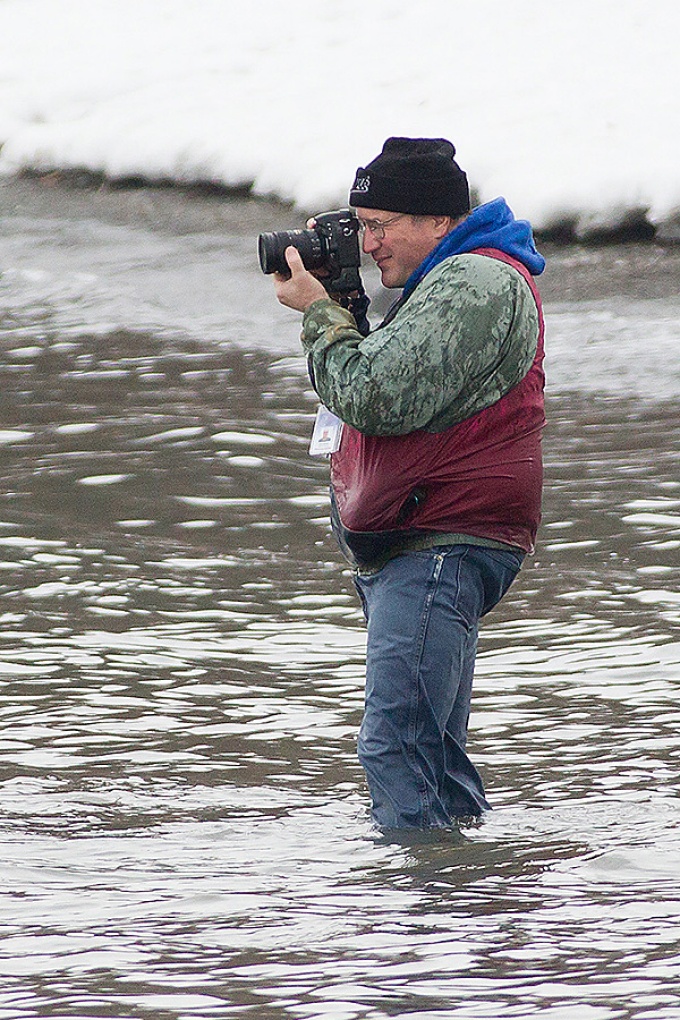 Ken in his hip waders, knee-deep in a lake, shooting a Polar Plunge